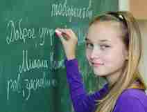 Young Girl Writing on a Chalkboard