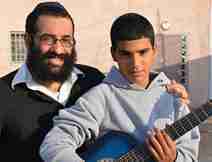 Man Volunteer of Colel Chabad Big Brother/Big Sister Program Posing for a Photo with Young Boy