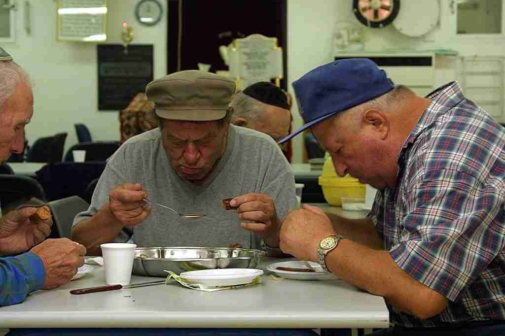 Three Men Having a Seudas Aniyim Meal